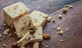 Halva almond nuts slices on wooden table background