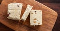 Halva almond nuts slices on wooden table background