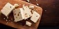 Halva almond nuts slices on wooden table background, top view