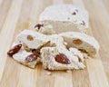 Halva with almonds on wooden cutting board.