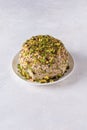 Halva with chopped pistachios on white with copy space