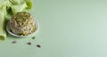 Halva with nuts and napkin on mint green paper background