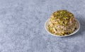 Halva with pistachios on gray background with copy space