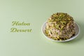 Halva with pistachios on green background with green text