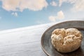 Halva plate wooden table oriental sweets cloudy sky background