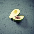 Halved Avocado on a Stone Background