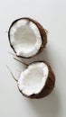 Halved coconut shells on white background, minimalistic still life. Tropical fruit concept Royalty Free Stock Photo