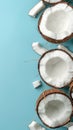 Halved coconuts arranged in a flat lay pattern on a blue background