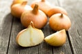 Halved fresh onion on wooden table