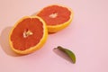 Halved grapefruit on a pink background Royalty Free Stock Photo