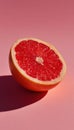 Halved Grapefruit with Vivid Red Pulp on Pastel Pink Background Royalty Free Stock Photo