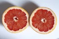 Halved grapefruit on a white background