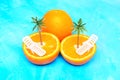 Halved Juicy Oranges with Tiny Lounge Chairs and Palm Trees Royalty Free Stock Photo
