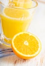 Halved orange and orange juice.