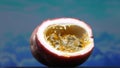 Close up of fresh passion fruit, bursting with sky-blue background. Comestible.