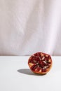 halved pomegranate desk front white curtain. High quality photo