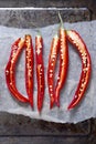 3 halved red chillies on a baking sheet