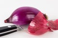 Halved red onion with a kitchen knife Royalty Free Stock Photo