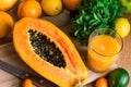 Halved ripe papaya, freshly pressed juice, fresh mint, citrus fruits, oranges, lemon, lime, kumquat