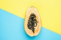 Halved Ripe Papaya on Split Duotone Yellow Blue Background. Styled Creative Image. Tropical Fruits Vacation Summer Beach Party Royalty Free Stock Photo