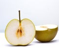 halved ripe pear on white background