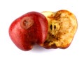 Halved rotten apple is isolated against a white background. Full clipping path. The red apple is spoiled