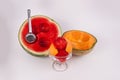 Halved scooped out watermelon and cantaloup fruit cup