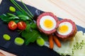 Halved Scotch egg with mashed potatoes, vegetables, greens Royalty Free Stock Photo