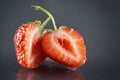 Halved strawberry on black grey natural background