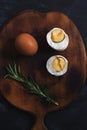 Halves of boiled egg on a wooden cutting board. Royalty Free Stock Photo