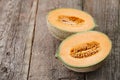 Halves of cantaloupe melon on old wooden planks