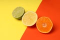 Halves of citrus fruits on two tone background Royalty Free Stock Photo