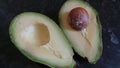 Halves of a cut avocado with a stone. Fruit Royalty Free Stock Photo