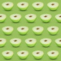 Halves of fresh apple on light green background, seamless pattern Royalty Free Stock Photo