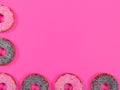 Halves of the glasses donuts on pink background. Christmas toy: chocolate and pink donats. Royalty Free Stock Photo