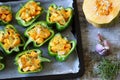 Halves of green peppers stuffed with slices of pumpkin.