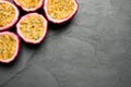 Halves of passion fruits maracuyas on black slate table. Space for text Royalty Free Stock Photo
