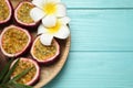 Halves of passion fruits maracuyas, palm leaf and flowers on light blue wooden table, top view. Space for text Royalty Free Stock Photo