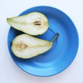 Halves of pear on a blue dish