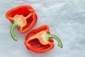 Halves of red sweet pepper on parchment paper. Royalty Free Stock Photo