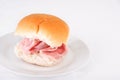 Ham bread roll or bap on a white plate Royalty Free Stock Photo