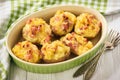 Ham and cheese jacket potatoes on dark background.