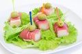 Ham with a melon and olives on a white plate. Royalty Free Stock Photo