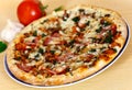 Ham, mushroom and vegetable pizza and tomato at th