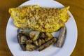 Ham and pepper omlette with sausage and red roasted potatoes Royalty Free Stock Photo