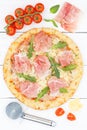 Ham pizza prosciutto from above portrait format baking ingredients on wooden board