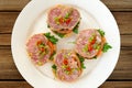 Ham sandwiches with chili, parsley and scallion on white plate t