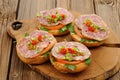 Ham sandwiches with chili, parsley and scallion on wooden board