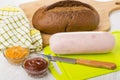 Sausage, knife on cutting board, bread, ketchup and squash caviar