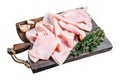 Ham Thin sliced on wooden cutting board with herbs. Isolated on white background, top view. Royalty Free Stock Photo